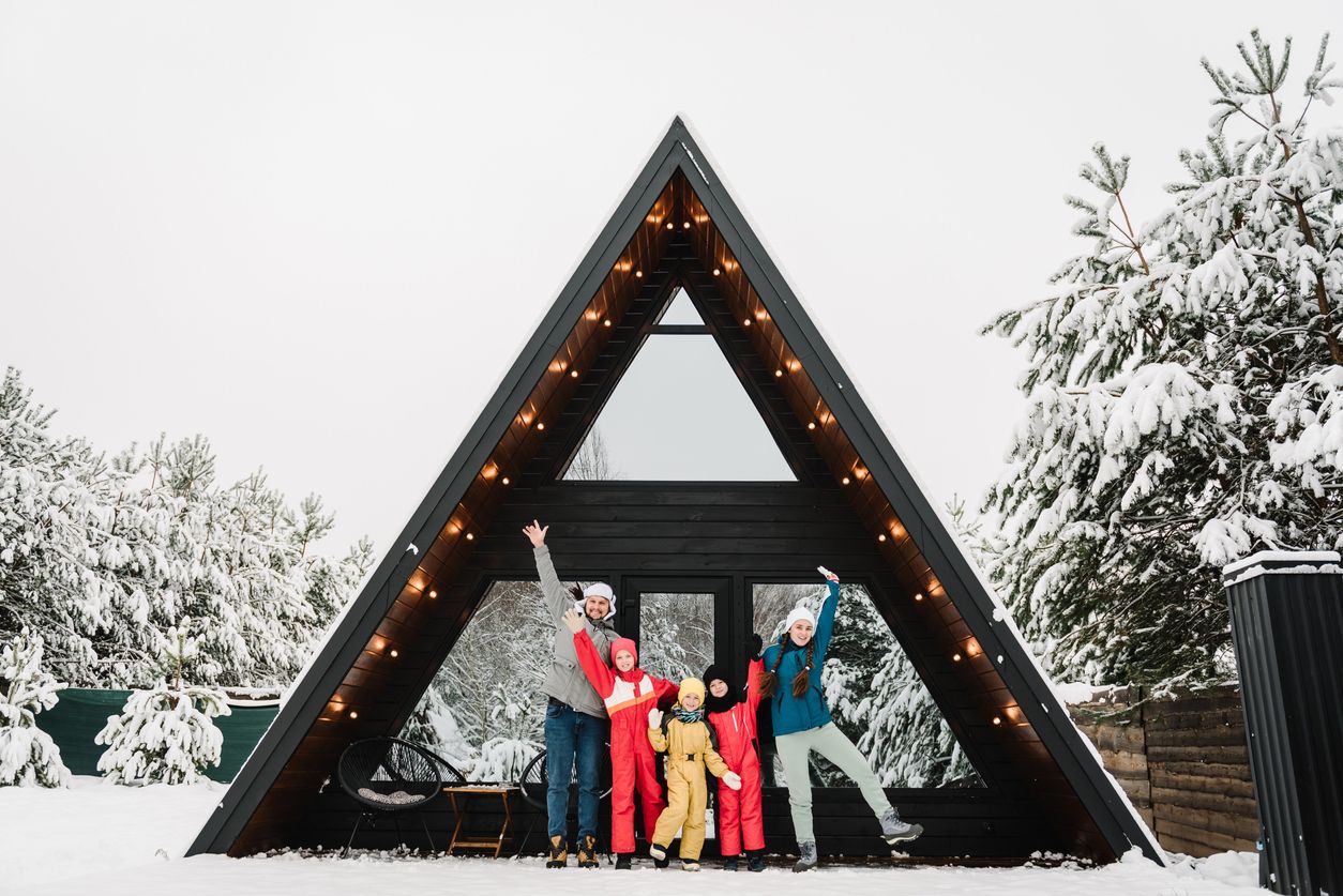 a triangle cottage on a snow day with four people