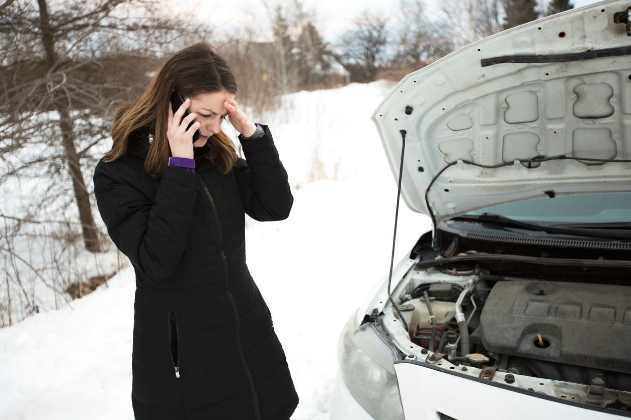 a person calling on phone in front of a car
